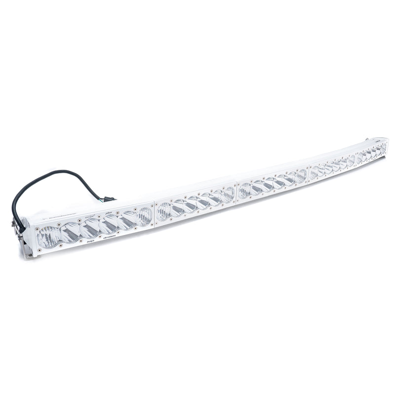 Baja Designs OnX6 White Arc LED Light Bar, whole product on a studio background: curved white LED light bar with clear lenses and a wiring harness on a white background