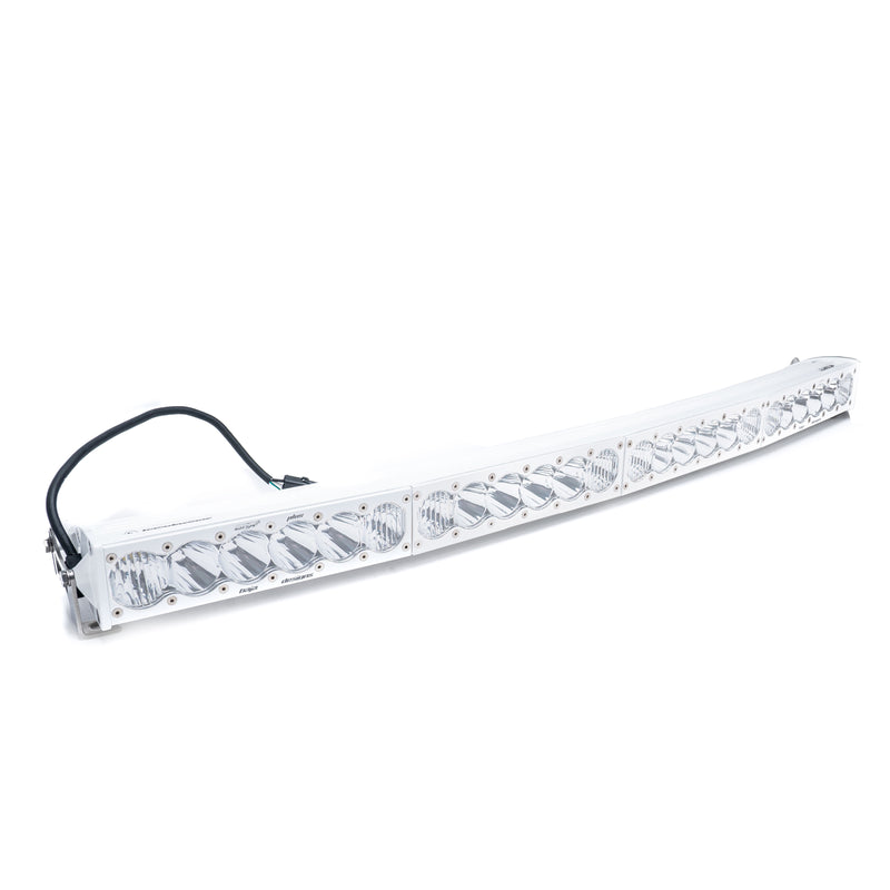 Baja Designs OnX6 White Arc LED Light Bar, whole product on a studio background: curved white LED light bar with clear lenses and a wiring harness on a white background
