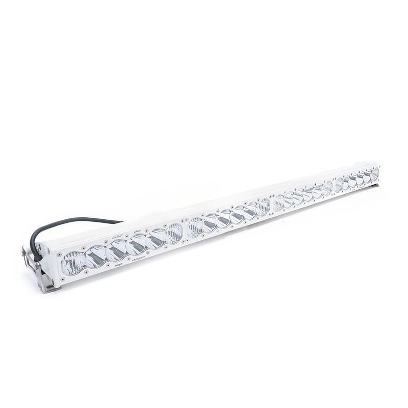 Baja Designs OnX6+ White Straight LED Light Bar, whole product on a studio background: long white LED light bar with clear lenses and a wiring harness on a white background