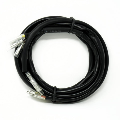 Baja Designs RTL-M License Plate Wiring Harness, whole product on a studio background: coiled black license plate light harness with spade terminals and printed cable jacket on white