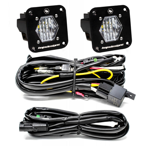 Baja Designs S1 Black Flush Mount LED Light Pod Reverse Kit, complete kit on a studio background: two black S1 flush mount pods, clear wide cornering lenses, with relay harness and extension harness on a white background