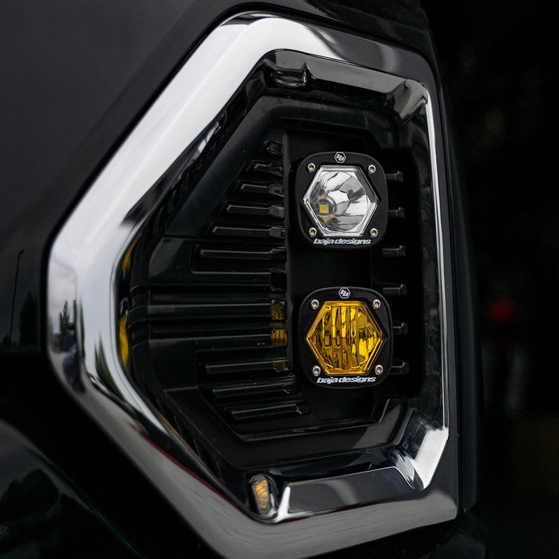 Baja Designs S1 Dual Fog Pocket Light Kit on a GMC Sierra 1500: clear S1 pod above an amber S1 pod in the chrome-trimmed fog pocket of a black GMC Sierra