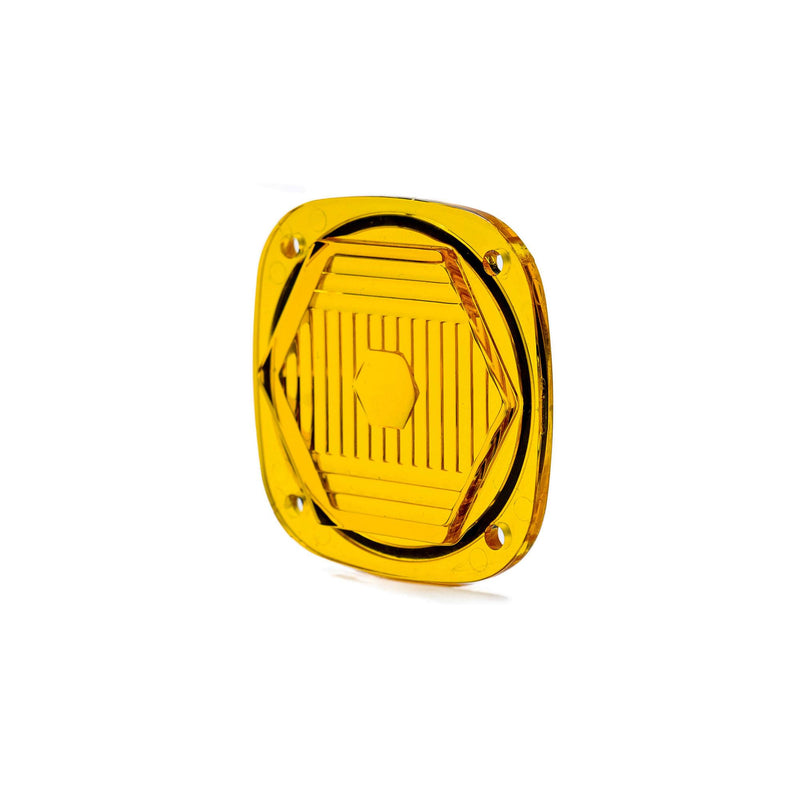 Baja Designs S1 Light Pod Lens Kit, complete kit on a studio background: A small amber S1 pod lens with a hexagon optic pattern and a seated black gasket on a white background