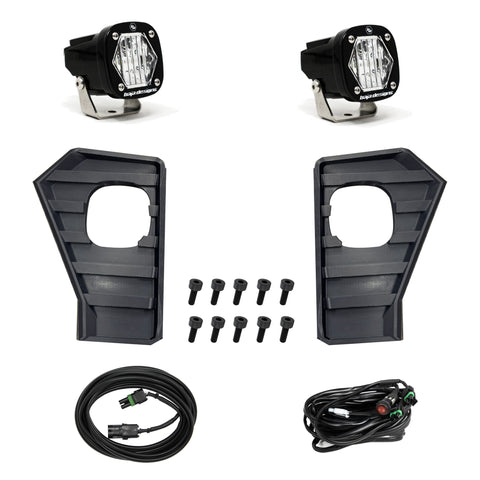Baja Designs S1 Vent Kit, complete kit on a studio background: A pair of S1 pods with clear lenses laid out with two louvered vent inserts, bolts and two wiring harnesses on white