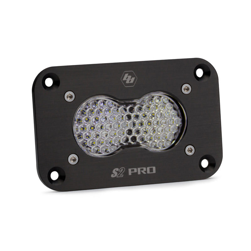 Baja Designs S2 Pro Black Flush Mount LED Auxiliary Light Pod, whole product on a studio background: A black S2 Pro flush mount LED pod with a clear dimpled work scene lens and a flat mounting flange