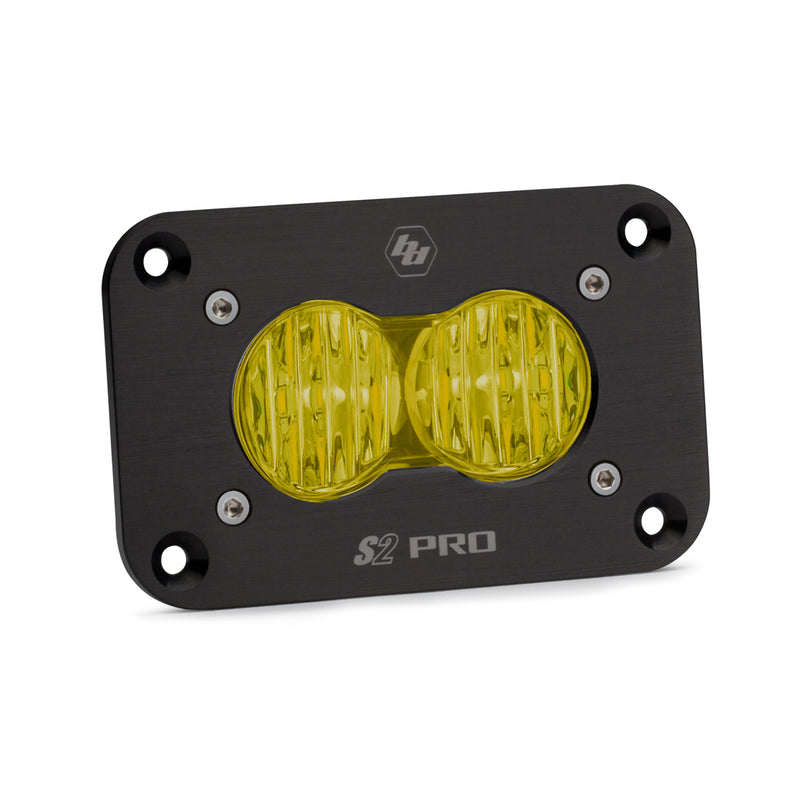Baja Designs S2 Pro Black Flush Mount LED Auxiliary Light Pod, whole product on a studio background: A black S2 Pro flush mount LED pod with an amber fluted wide cornering lens and a flat mounting flange