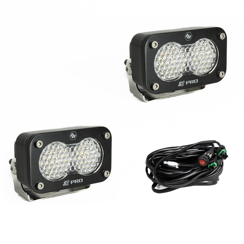 Baja Designs S2 Pro Black LED Auxiliary Light Pod Pair, whole product on a studio background: two black S2 Pro LED pods with clear dimpled work scene style lenses and a wiring harness with switch on a white background