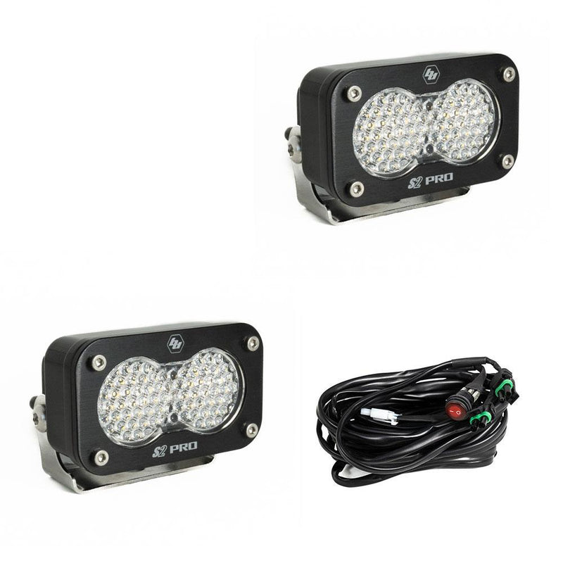 Baja Designs S2 Pro Black LED Auxiliary Light Pod Pair, whole product on a studio background: two black S2 Pro LED pods with clear dimpled work scene style lenses and a wiring harness with switch on a white background