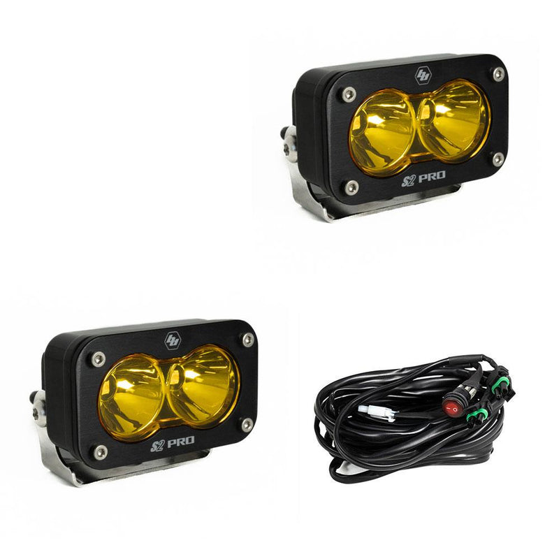 Baja Designs S2 Pro Black LED Auxiliary Light Pod Pair, whole product on a studio background: two black S2 Pro LED pods with amber smooth spot reflector lenses and a wiring harness with switch on a white background