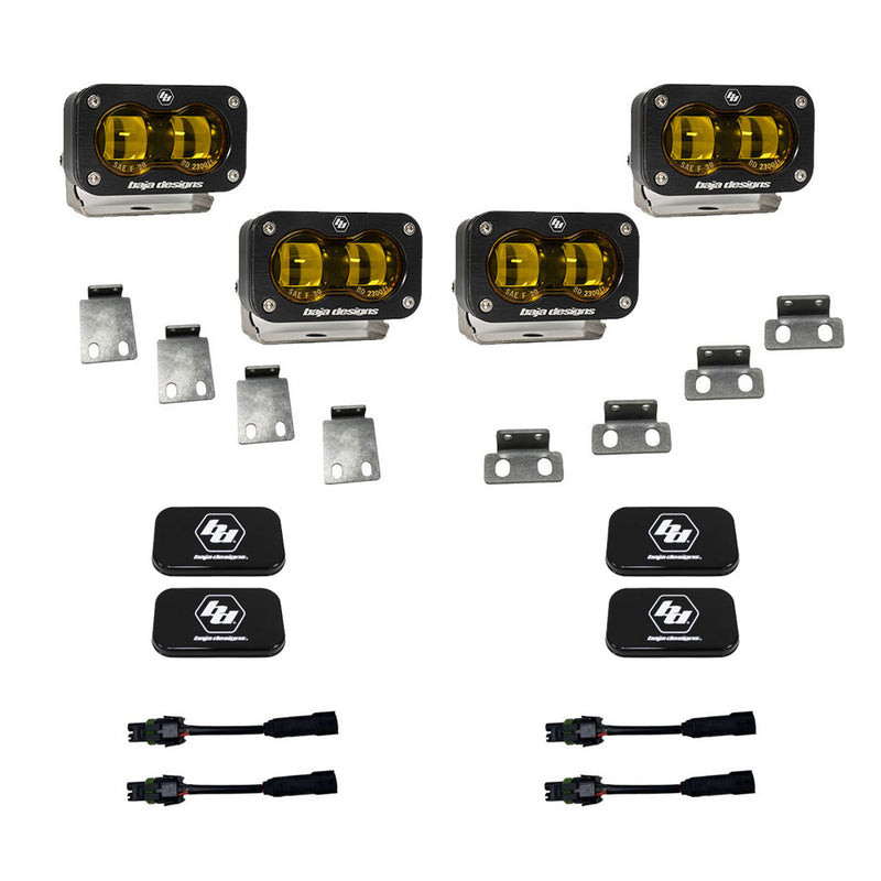Baja Designs S2 SAE Dual Fog Pocket Kit, complete kit on a studio background: four amber lens S2 SAE pods with steel mounting tabs, black rock guard covers and adapter harnesses on white