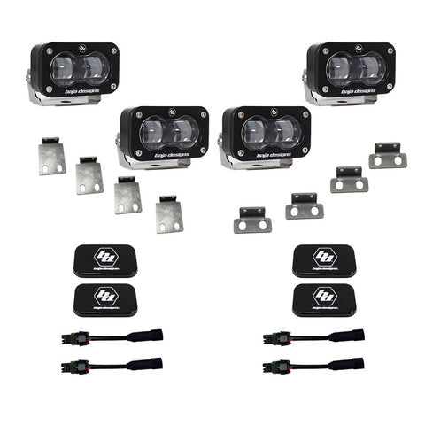 Baja Designs S2 SAE Dual Fog Pocket Kit, complete kit on a studio background: four clear lens S2 SAE pods with steel mounting tabs, black rock guard covers and adapter harnesses on white
