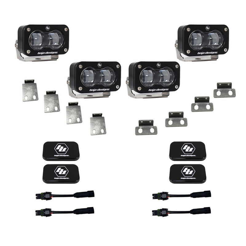 Baja Designs S2 SAE Dual Fog Pocket Kit, complete kit on a studio background: four clear lens S2 SAE pods with steel mounting tabs, black rock guard covers and adapter harnesses on white