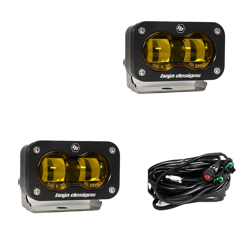 Baja Designs S2 SAE LED Auxiliary Light Pod Pair, whole product on a studio background: two black S2 SAE LED pods with amber projector lenses and a wiring harness with switch on a white background