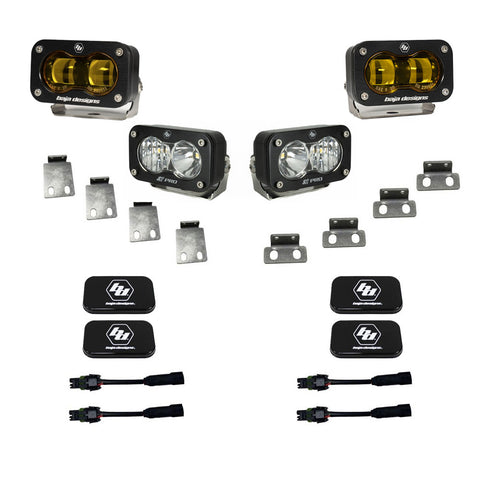 Baja Designs S2 SAE/S2 Pro Fog Pocket Kit, complete kit on a studio background: two amber S2 SAE fog pods and two clear S2 Pro pods laid out with mounting tabs, black Baja Designs covers and adapter harnesses on white