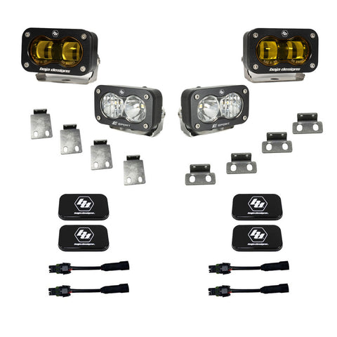 Baja Designs S2 SAE/S2 Sport Fog Pocket Kit, complete kit on a studio background: two amber S2 SAE pods and two clear S2 Sport pods with steel mounting tabs, black covers and adapter harnesses on white