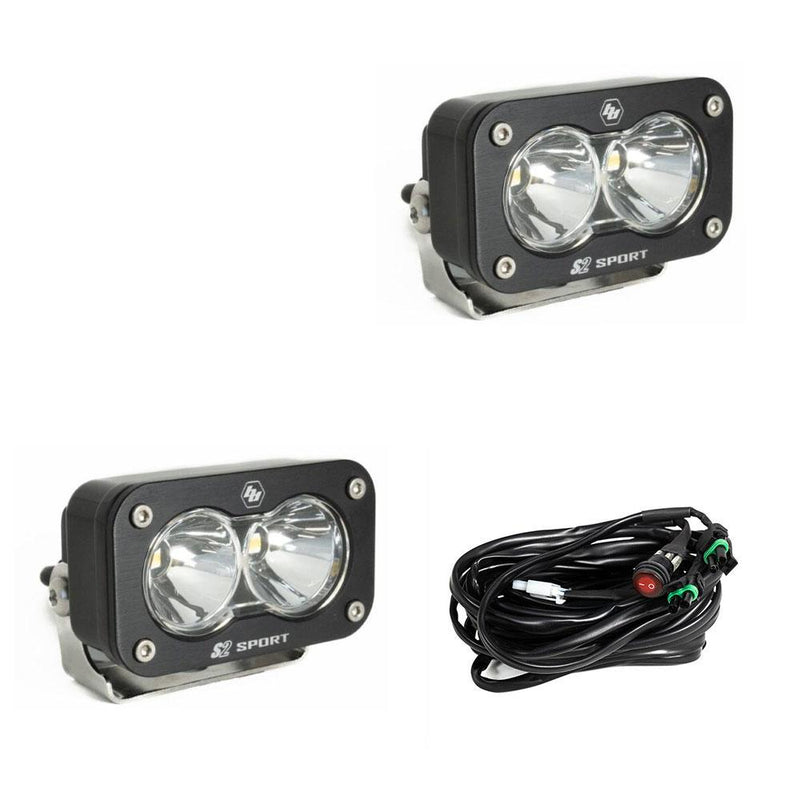 Baja Designs S2 Sport Black LED Auxiliary Light Pod Pair, whole product on a studio background: pair of black S2 Sport light pods with clear spot reflectors and a wiring harness on a white background