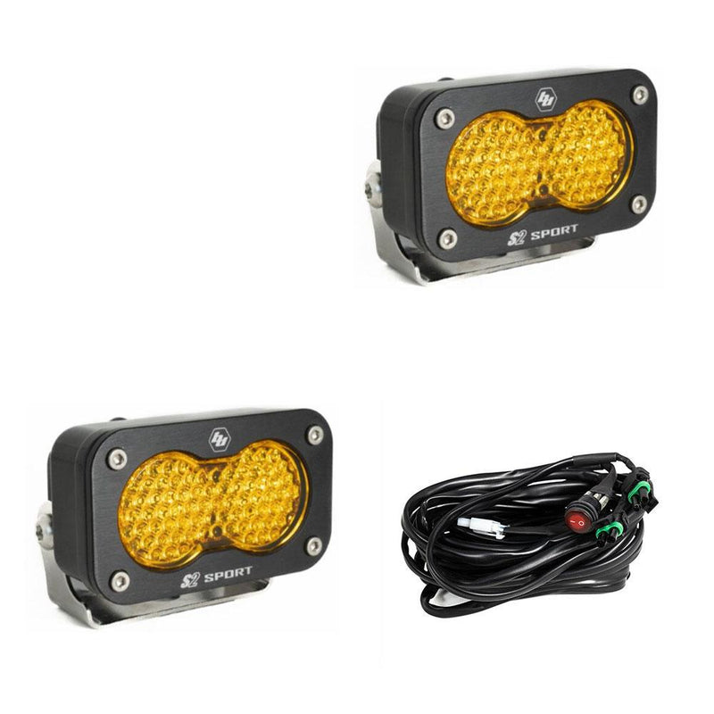Baja Designs S2 Sport Black LED Auxiliary Light Pod Pair, whole product on a studio background: pair of black S2 Sport light pods with amber dimpled lenses and a wiring harness on a white background
