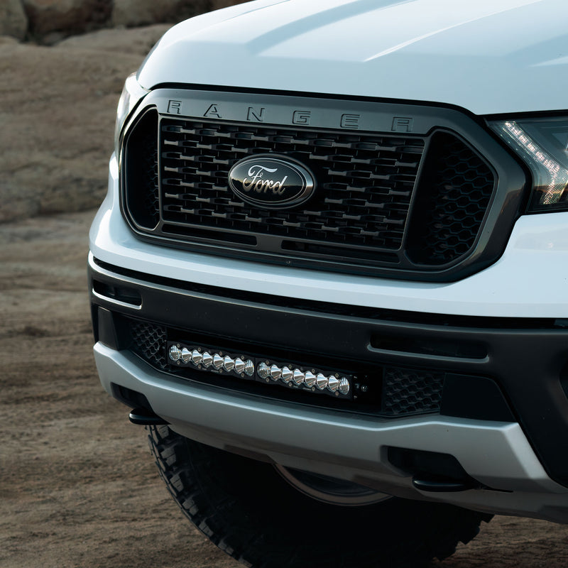 Baja Designs S8 20" Grille Light Kit on a Ford Ranger: close view of a white Ford Ranger front end with a light bar mounted in the lower grille opening