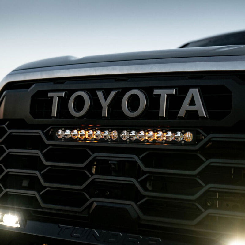 Baja Designs S8 Straight LED Light Bar on a Toyota Tundra: lit S8 LED light bar mounted in the grille of a dark gray Toyota Tundra just below the TOYOTA lettering