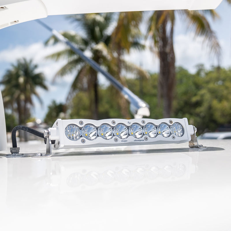Baja Designs S8 White Straight LED Light Bar on a boat: white housing 10" S8 LED light bar mounted on a glossy white boat hardtop with palm trees behind