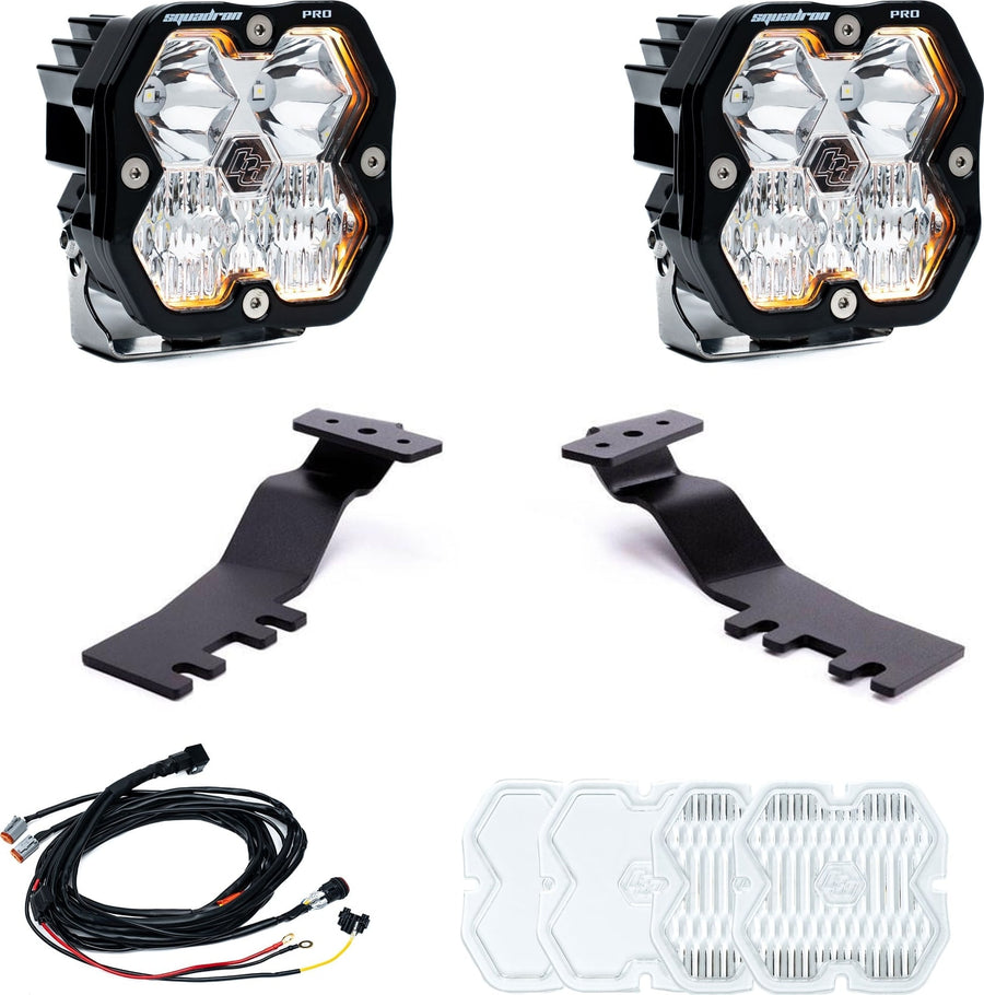 A-Pillar Light Kits by Baja Designs: A pair of Squadron Pro pods with amber backlight trim, two black A-pillar brackets, a wiring harness and spare clear lens covers on white.