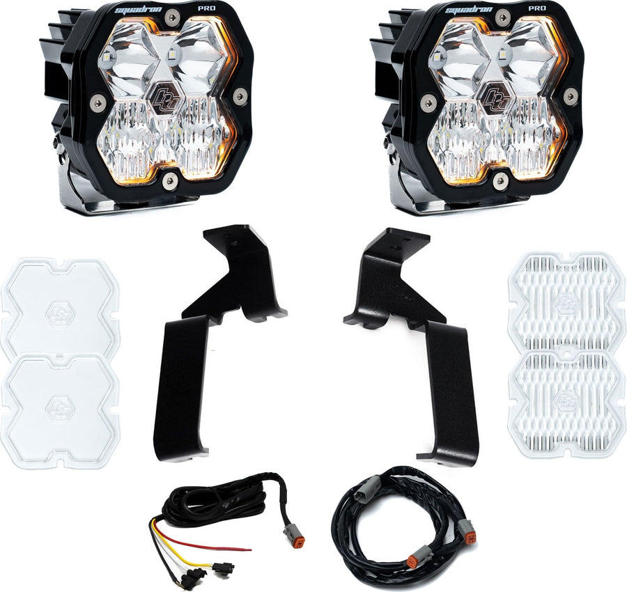 A-Pillar Light Kits by Baja Designs: A pair of Squadron Pro pods with tall black A-pillar brackets, two harness sections and spare clear lens covers on white.