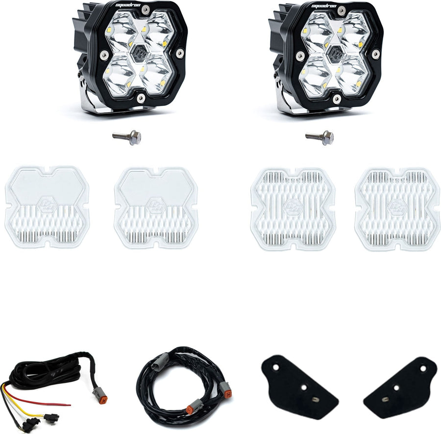 A-Pillar Light Kits by Baja Designs: A Squadron Sport A-pillar kit with two pods, bolts, spare clear lens covers, harness sections and small black brackets on white.