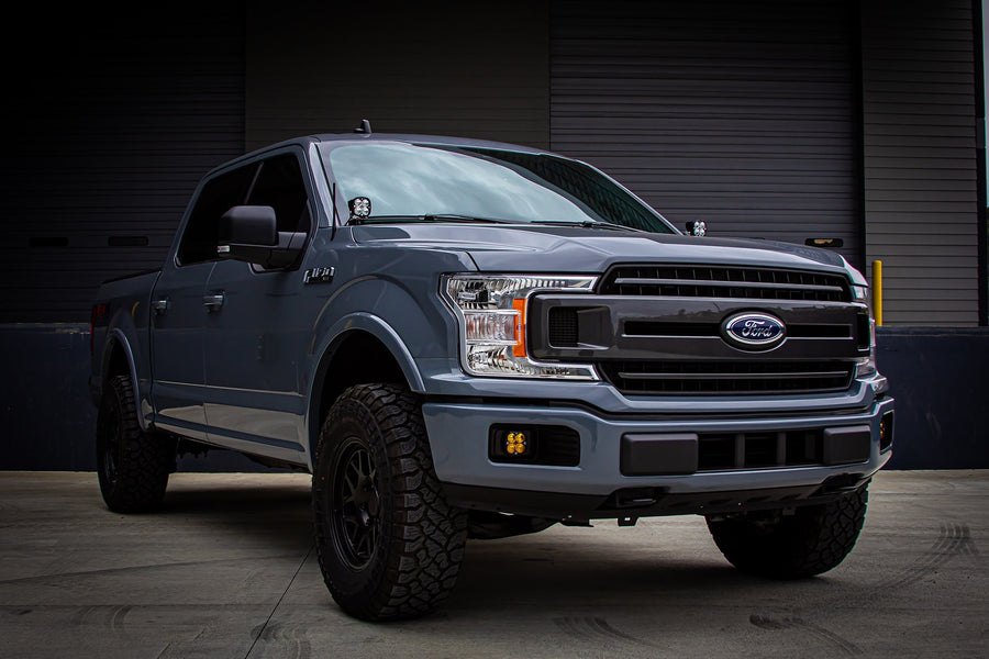 A-Pillar Light Kits by Baja Designs: A gray Ford F-150 seen from the front three-quarter with a Squadron pod on the A-pillar.