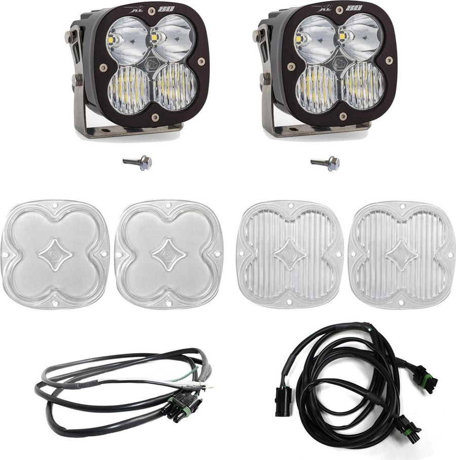 A-Pillar Light Kits by Baja Designs: Two black XL 80 pods with clear lenses shown with mounting bolts, four clear lens covers and two wiring harnesses on white.