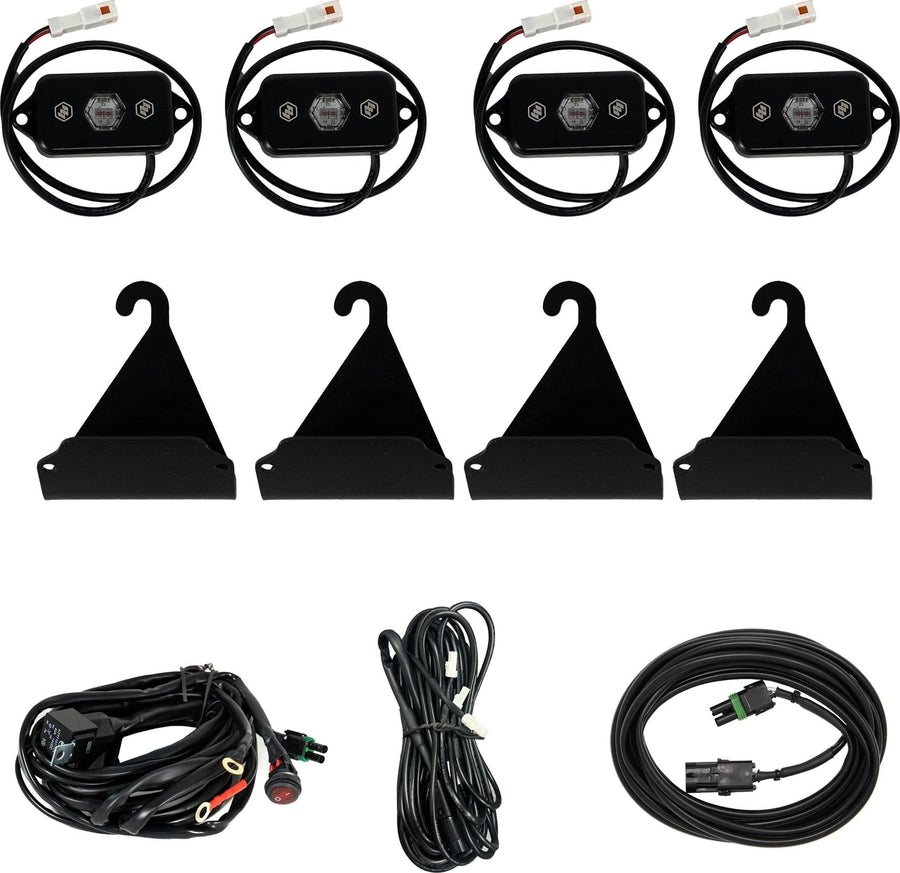 Vehicle Light Mount Kits by Baja Designs: Four LED rock-light pods with four hook brackets, a switched wiring harness and extension cables on white.