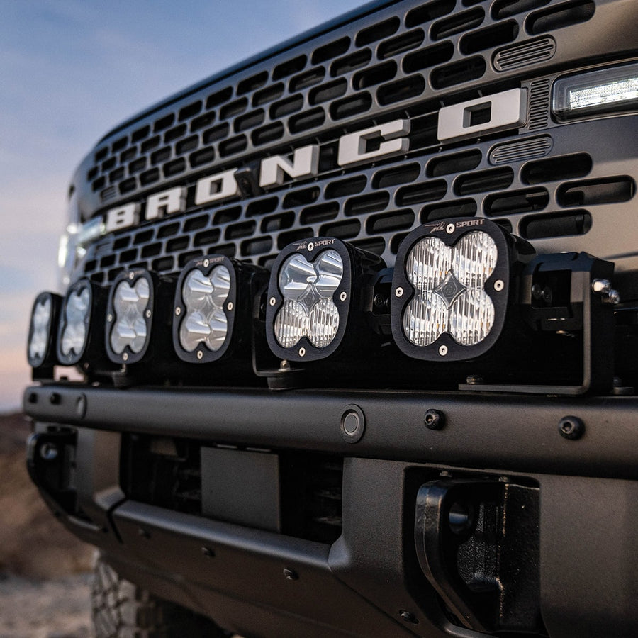 Bumper Light Kits by Baja Designs: Close front view of six XL linkable pods mounted across the steel front bumper of a dark Ford Bronco.