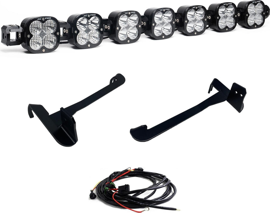 Bumper Light Kits by Baja Designs: Seven XL Pro linkable pods joined as one bar with two long black mounting brackets and a wiring harness on white.