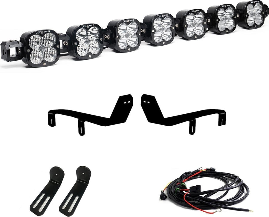Bumper Light Kits by Baja Designs: A seven-pod XL Linkable light bar kit on white with two bumper brackets, two slotted mounts and a relay wiring harness.