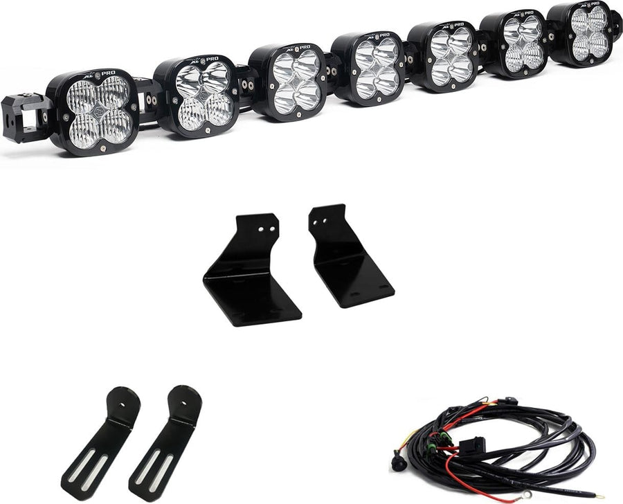 Bumper Light Kits by Baja Designs: A seven-pod XL Linkable light bar kit on white with two bumper brackets, two slotted mounts and a relay wiring harness.