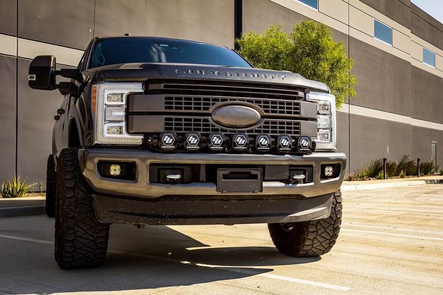 Bumper Light Kits by Baja Designs: A gray Ford Super Duty with a seven-pod XL Linkable light bar fitted with black covers across the bumper.
