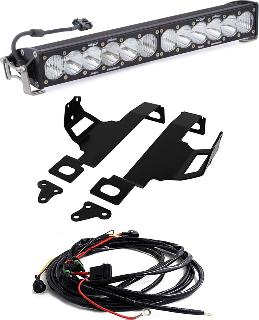 Bumper Light Kits by Baja Designs: An OnX6+ light bar with clear lenses shown with two black mounting brackets and a wiring harness on white.