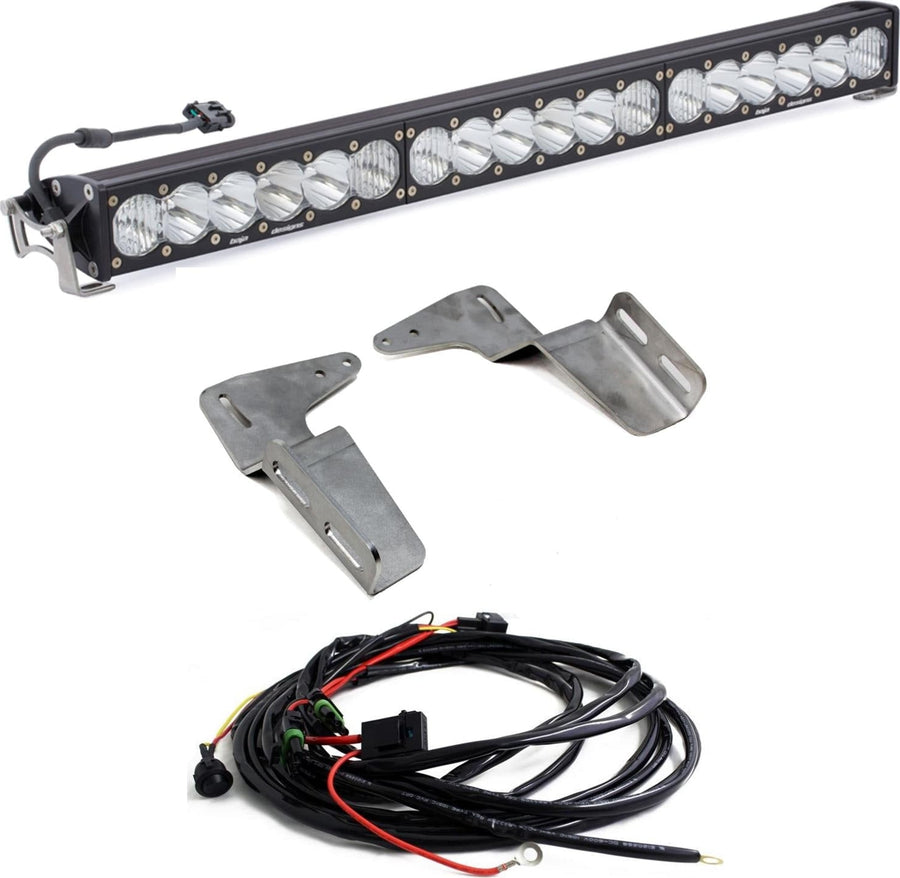 Bumper Light Kits by Baja Designs: An OnX6+ light bar with clear lenses shown with two bare steel mounting brackets and a wiring harness on white.