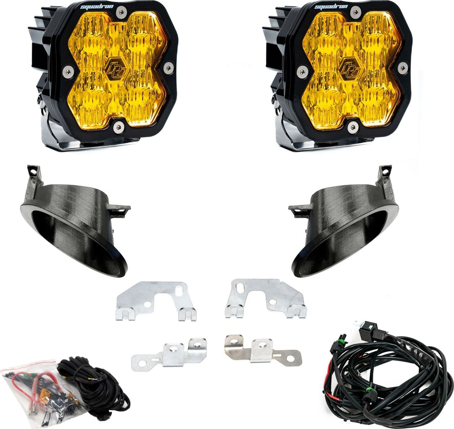 Fog Light Kits by Baja Designs: Fog pocket kit with two square amber lens pods, two black bezel cups, steel brackets, hardware and a harness on white.