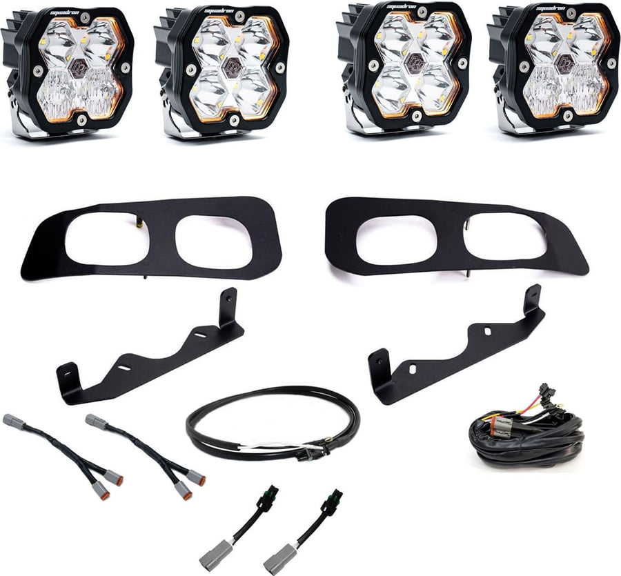 Fog Light Kits by Baja Designs: Dual fog pocket kit with four clear square Squadron Sport pods, two black twin bezels, brackets and harnesses on white.