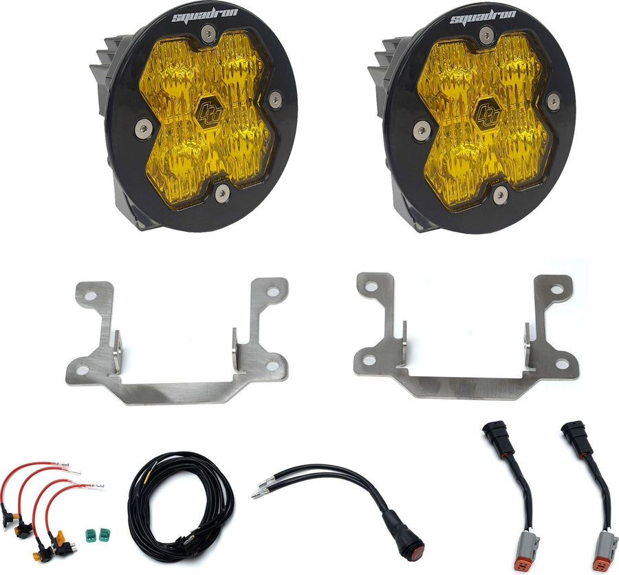 Fog Light Kits by Baja Designs: Pair of round amber lens fog lights with steel brackets, adapter harnesses and wiring on white.