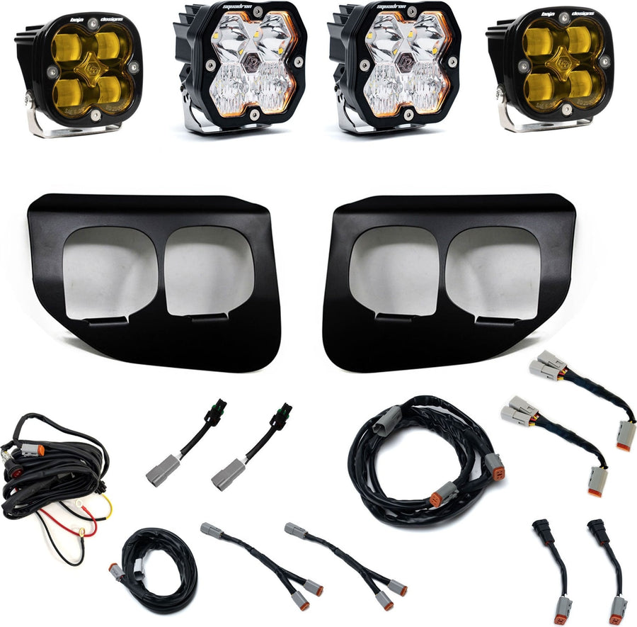 Fog Light Kits by Baja Designs: Dual fog pocket light kit with four square Squadron pods, two black dual-opening bezels, wiring harnesses and adapters on white.