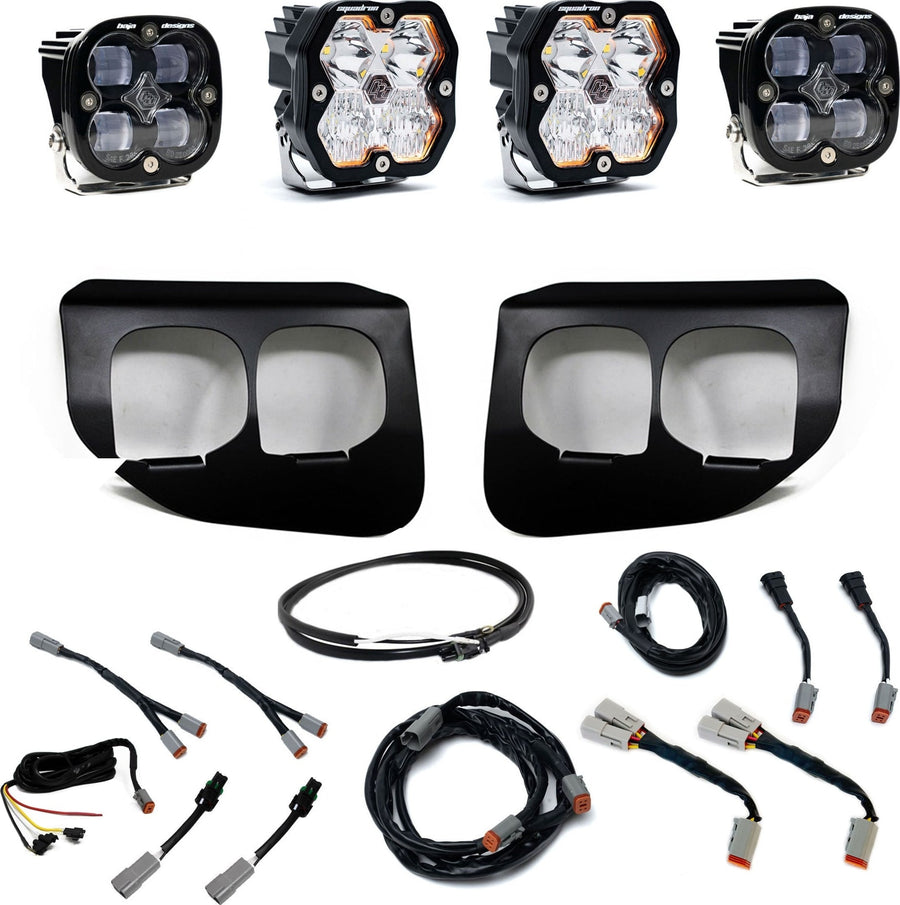 Fog Light Kits by Baja Designs: Dual fog pocket light kit with four square Squadron pods, two black dual-opening bezels, wiring harnesses and adapters on white.