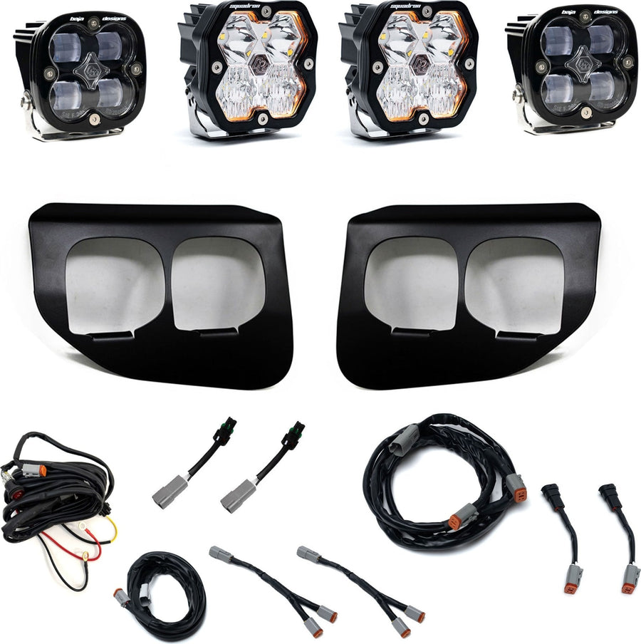 Fog Light Kits by Baja Designs: Dual fog pocket light kit with four square Squadron pods, two black dual-opening bezels, wiring harnesses and adapters on white.