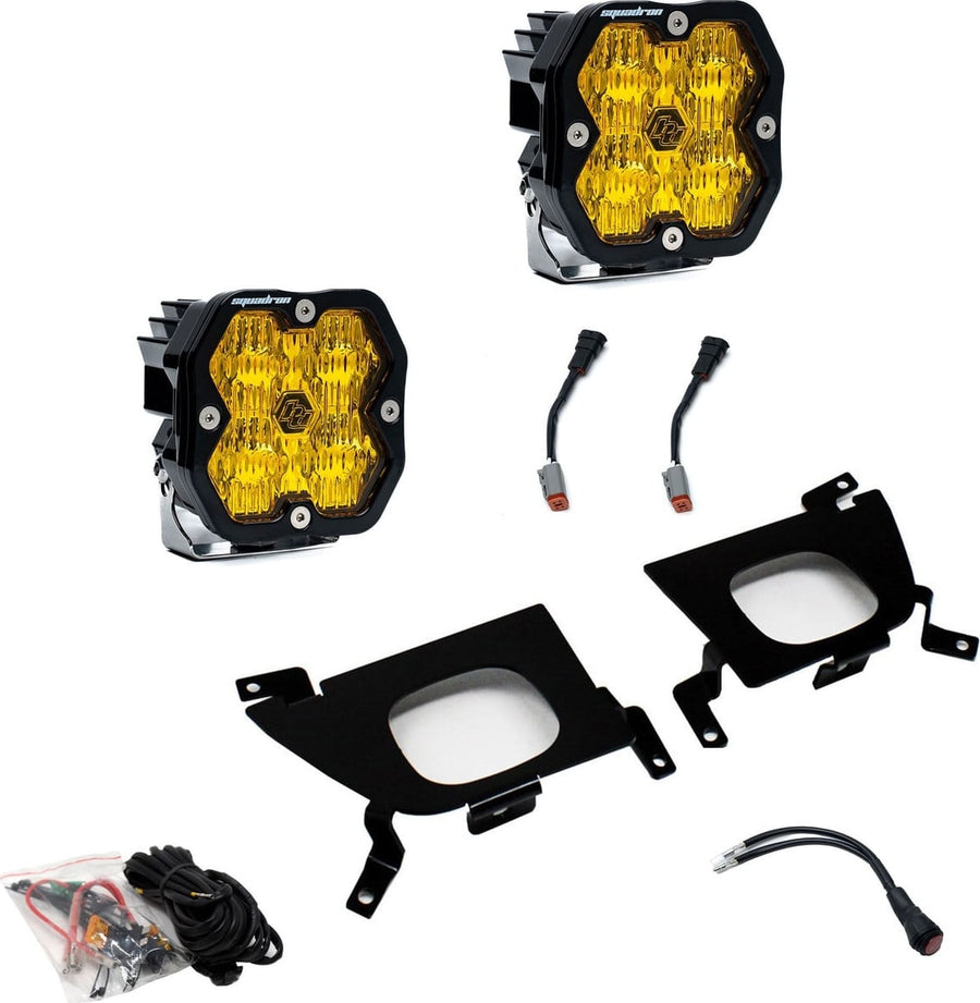 Fog Light Kits by Baja Designs: Pair of square Squadron pods with amber lenses, two black fog pocket brackets, wiring harness and adapters on white.