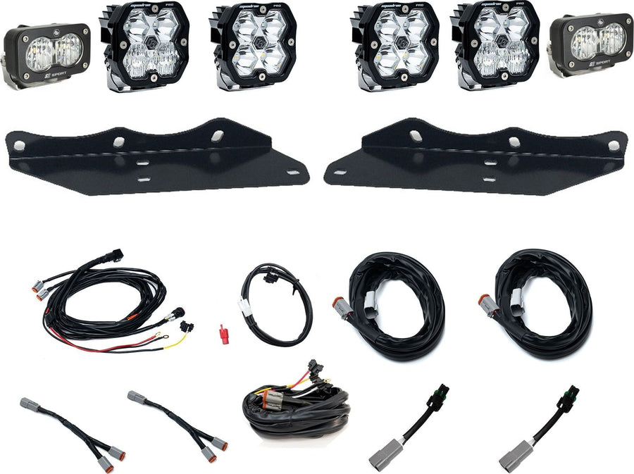 Fog Light Kits by Baja Designs: Fog pocket kit with four clear square Squadron pods, two clear S2 pods, two black mounting brackets, harnesses and adapters on white.