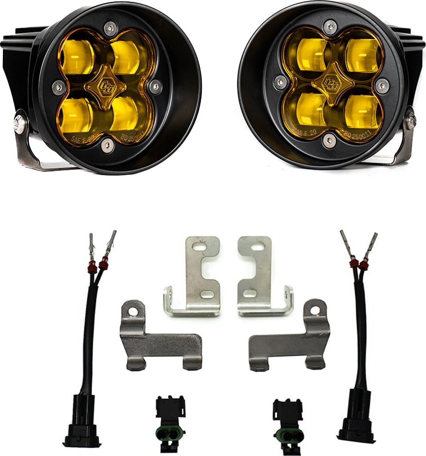 Fog Light Kits by Baja Designs: Pair of round amber-lens Squadron-R fog pods with four steel brackets, two pigtail harnesses and two connectors on white.
