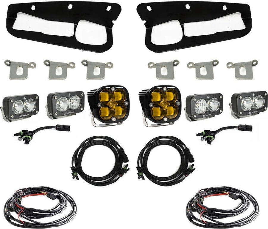 Fog Light Kits by Baja Designs: Bumper fog pocket kit with two black bezels, steel brackets, four S2 pods and two Squadron pods (amber Squadron pods and clear S2 pods) and harnesses on white.