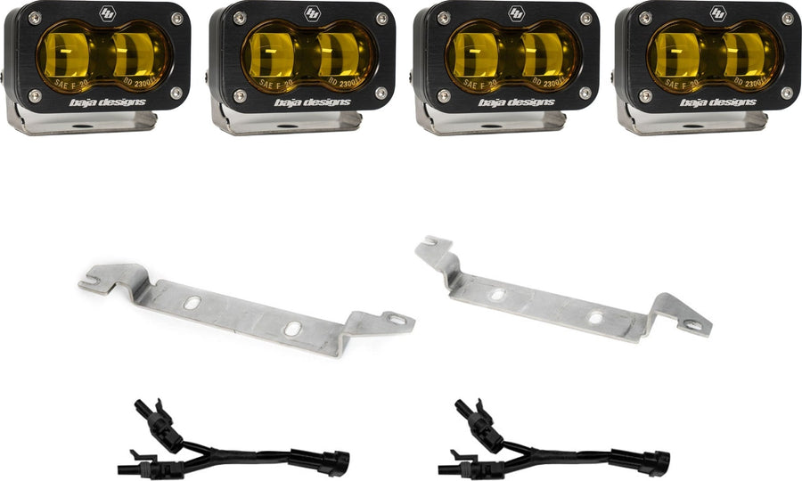 Fog Light Kits by Baja Designs: Four black S2 SAE fog pods with amber lenses, two silver bumper brackets and two Y harnesses on white.
