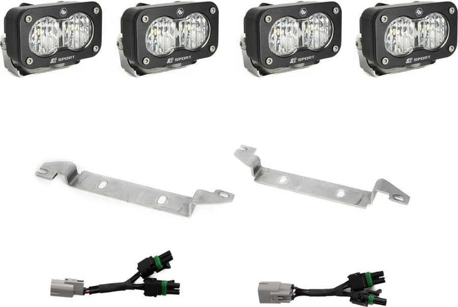 Fog Light Kits by Baja Designs: Four black S2 Sport pods with clear lenses, two silver bumper brackets and two Y harnesses with gray factory plugs on white.