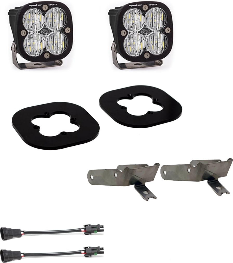 Fog Light Kits by Baja Designs: Pair of black Squadron Sport fog pods with clear lenses, two black gasket plates, two steel brackets and two adapter harnesses on white.